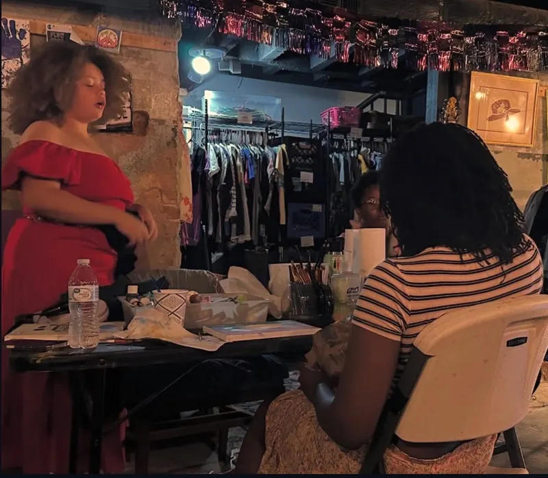 An art session in the basement studio beside the racks of Bella’s Free Community Store