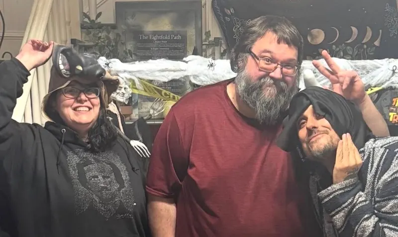 Three friends in costume ham it up at a Halloween gathering in the house