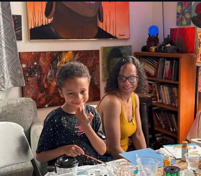 A smiling boy and his mom at the art table