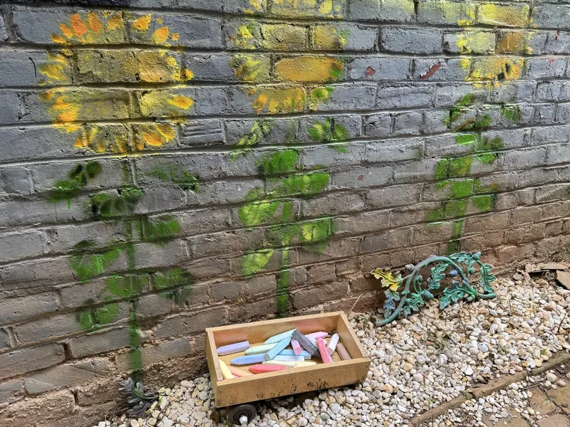 Sunflowers painted on the brick wall of the Rachel Burns Zen Garden